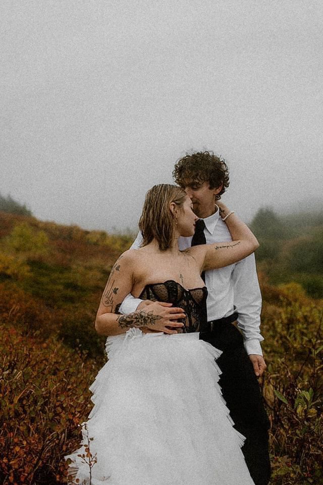 Elopement photos of a couple in the rain and fog