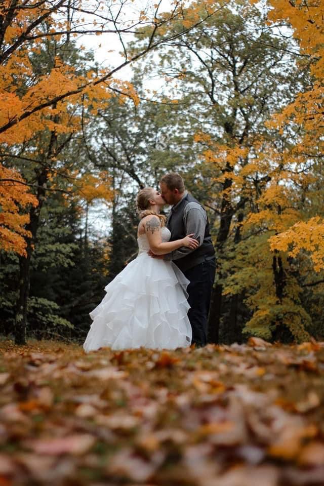 Bride and groom in an autumn forest