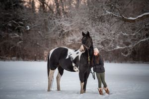 Girl with black and white horse