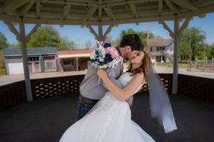 A newlywed couple kiss