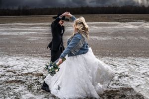 A new bride is twirled by her husband