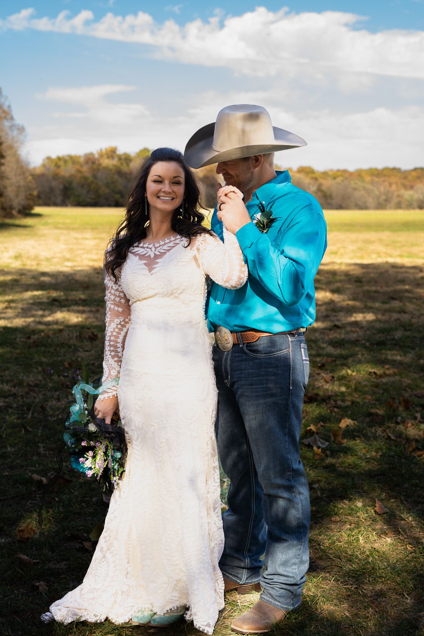 A groom kisses bride's hand