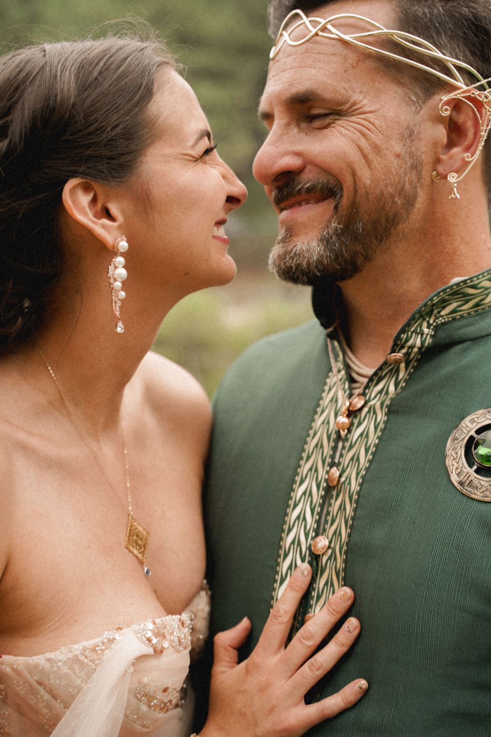 Intimate wedding portrait showing joyful expressions and elegant formal attire.