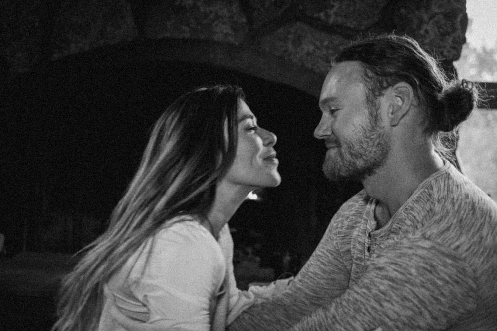 Black and white romantic portrait of a couple sharing an intimate moment together.