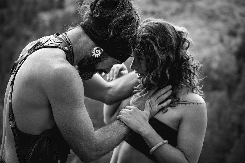 Emotional black and white portrait of a couple sharing an intimate embrace in nature.