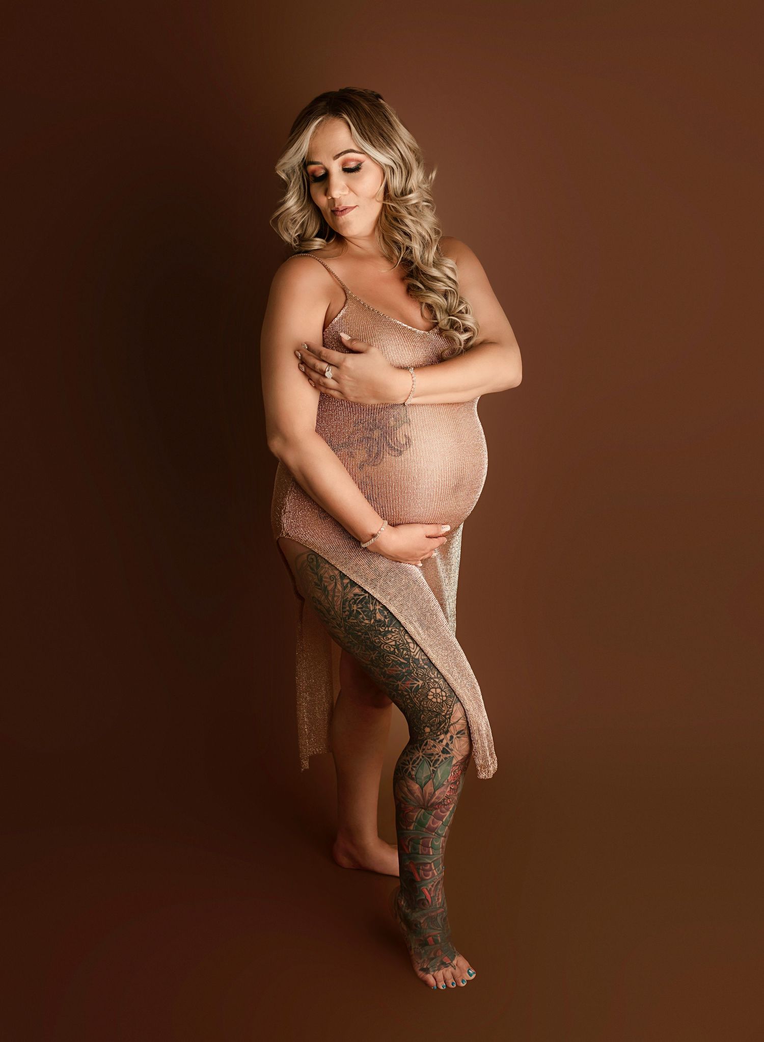 Maternity photography near me Riverside CA, woman in gold maternity outfit