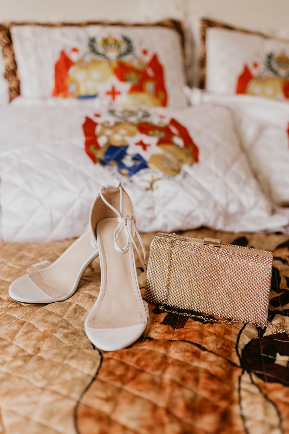 Heels and purse displayed on the bed for the graduate