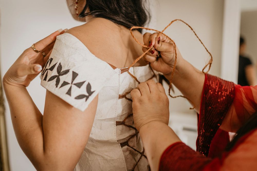 Details of a Tongan Cultural dress being secured on graduate