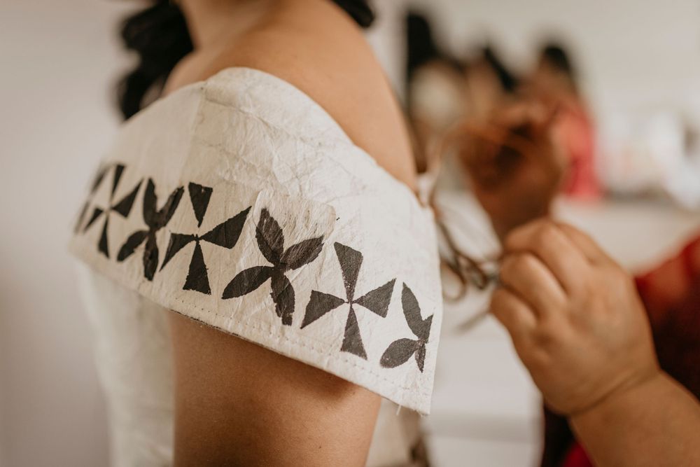 details of the graduates dress with ancient tongan markings