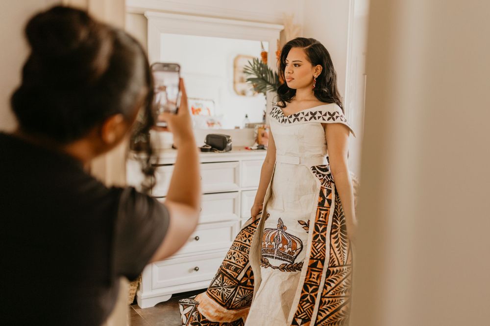 Family admire graduate in Tongan Cultural attire as she gets ready for her formal