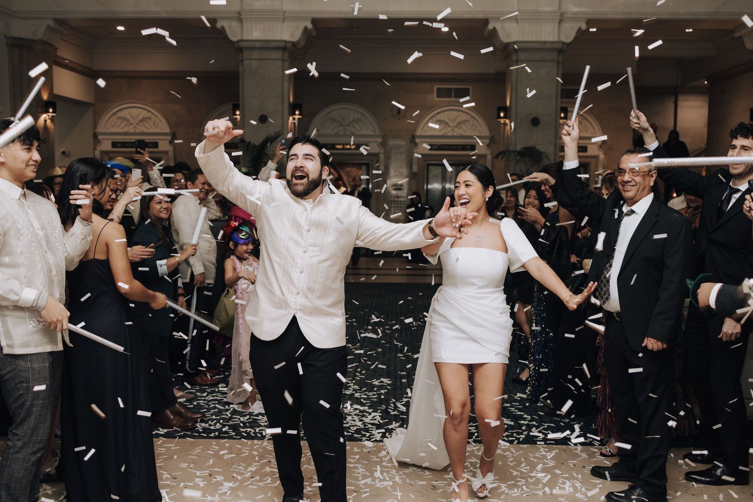 Celebratory moment with confetti during indoor wedding reception.