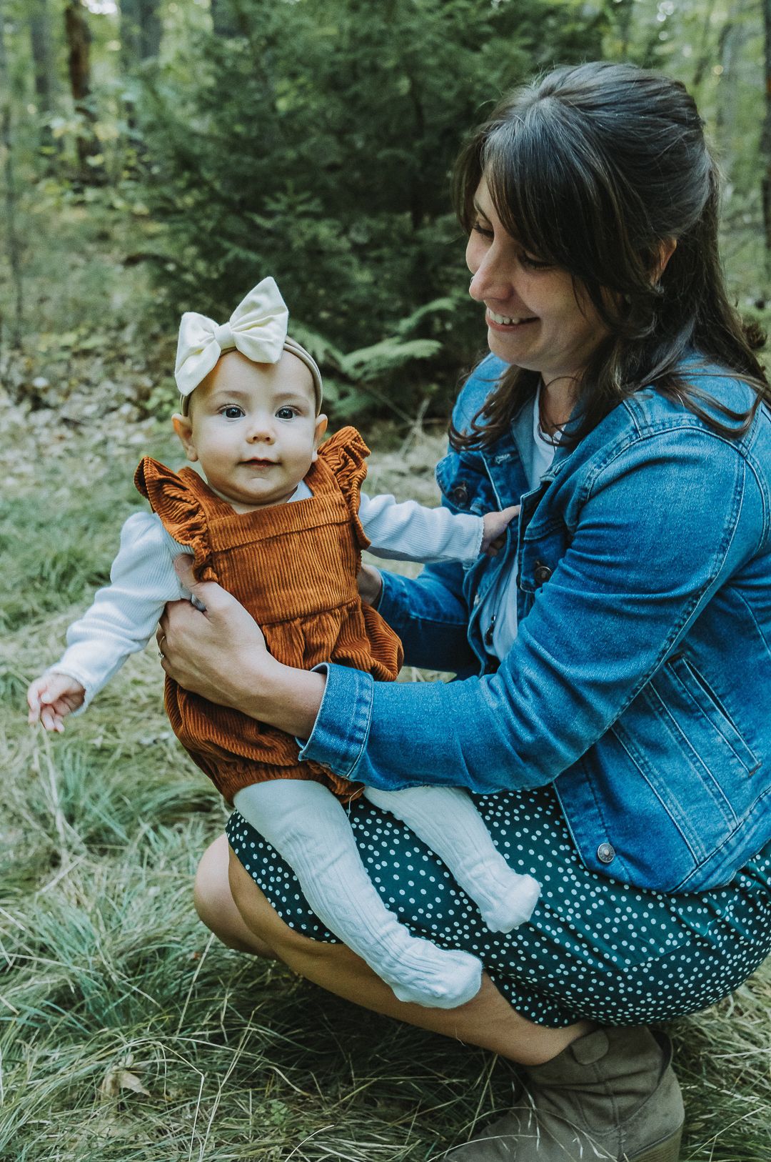 A mother and her daughter smile together during a fall family photo session in Brunswick, Maine.