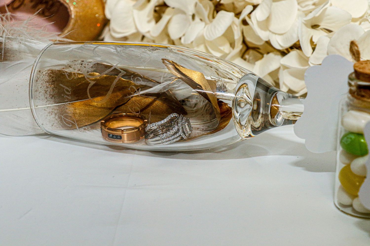 Elegant table setting with white floral centerpieces and crystal glassware.