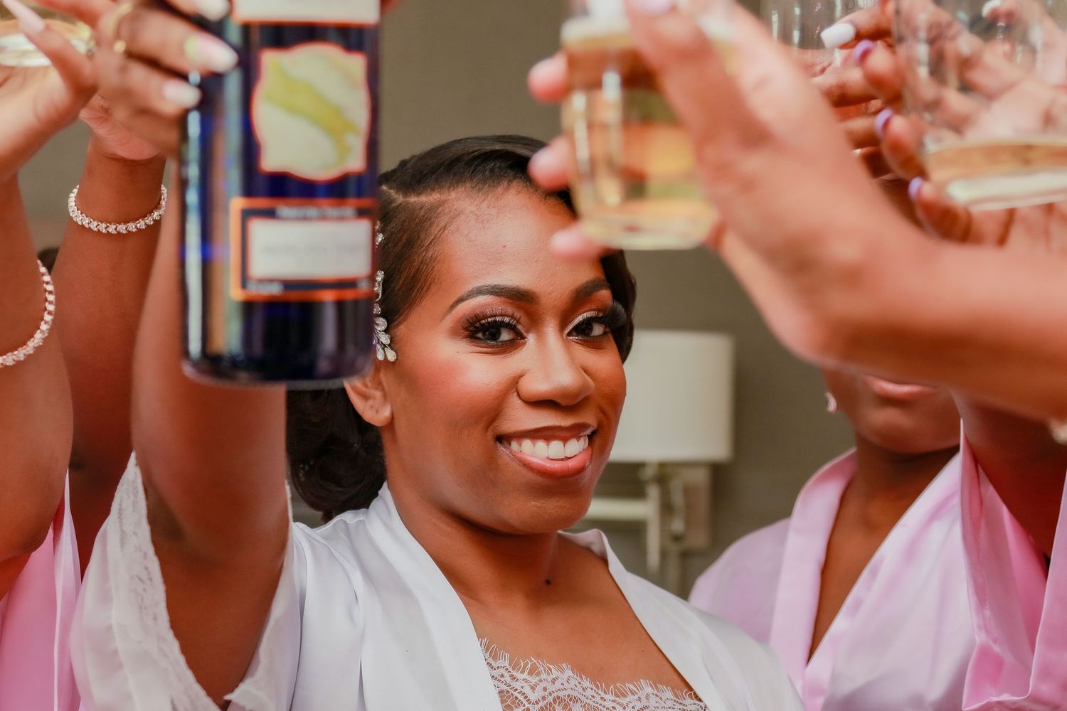 Wedding party celebrating with champagne and joyful expressions.
