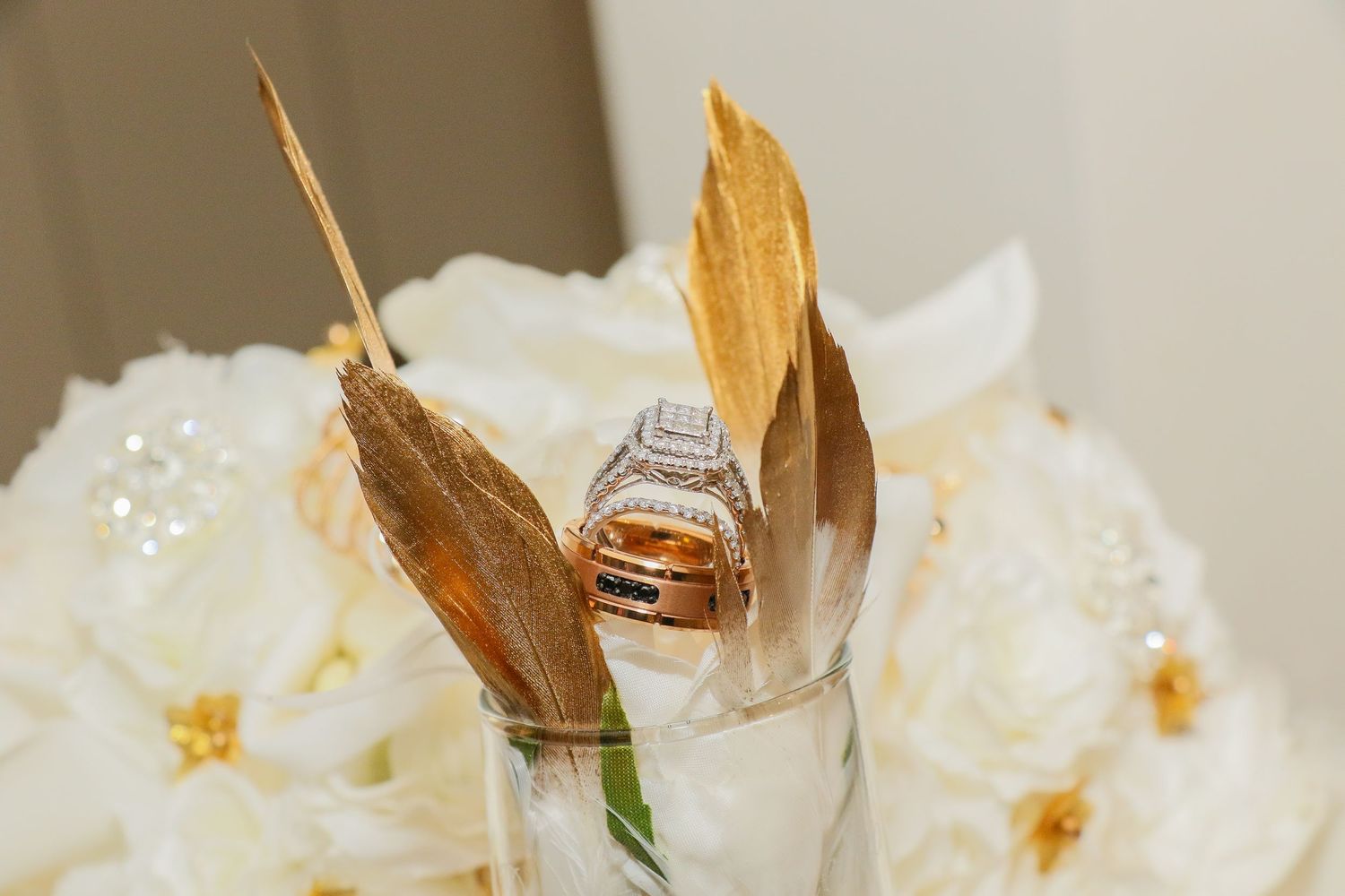 Close-up of white wedding flowers and decorative elements on reception table.