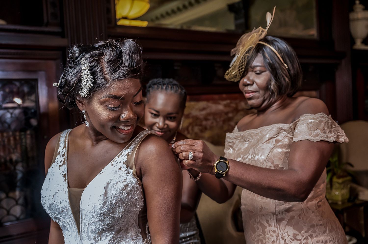Joyful wedding celebration with bride and bridesmaids sharing emotional embraces in elegant dresses.