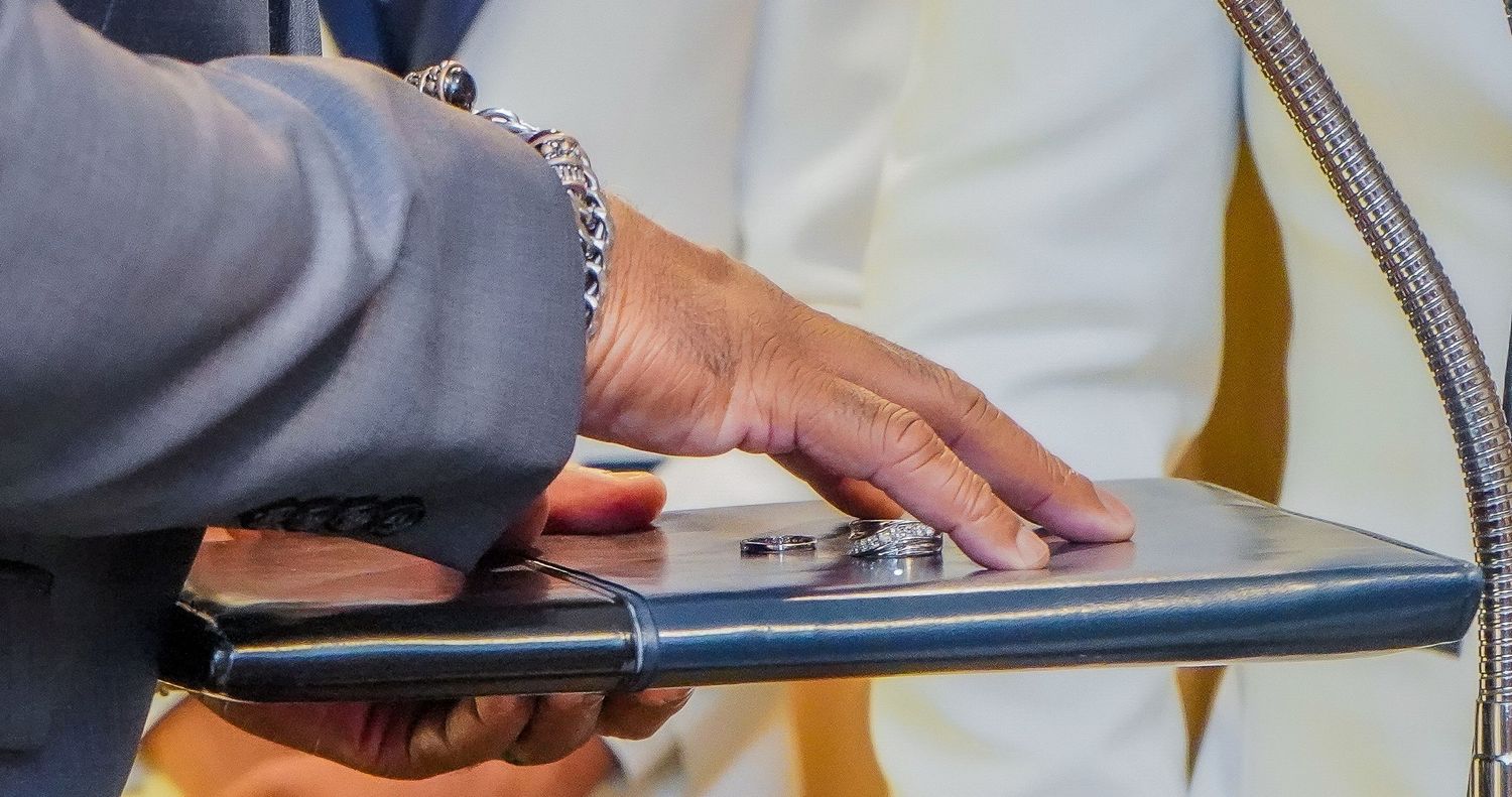 Close-up detail of elegant wedding attire and accessories.