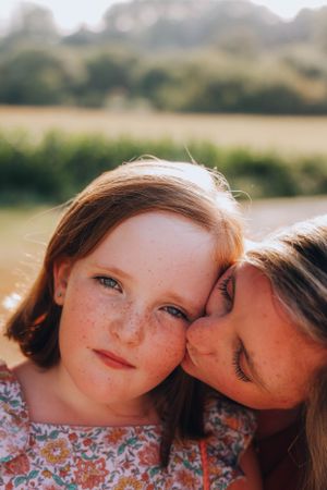 Sweet close-up moment captured in natural sunlight outdoors.