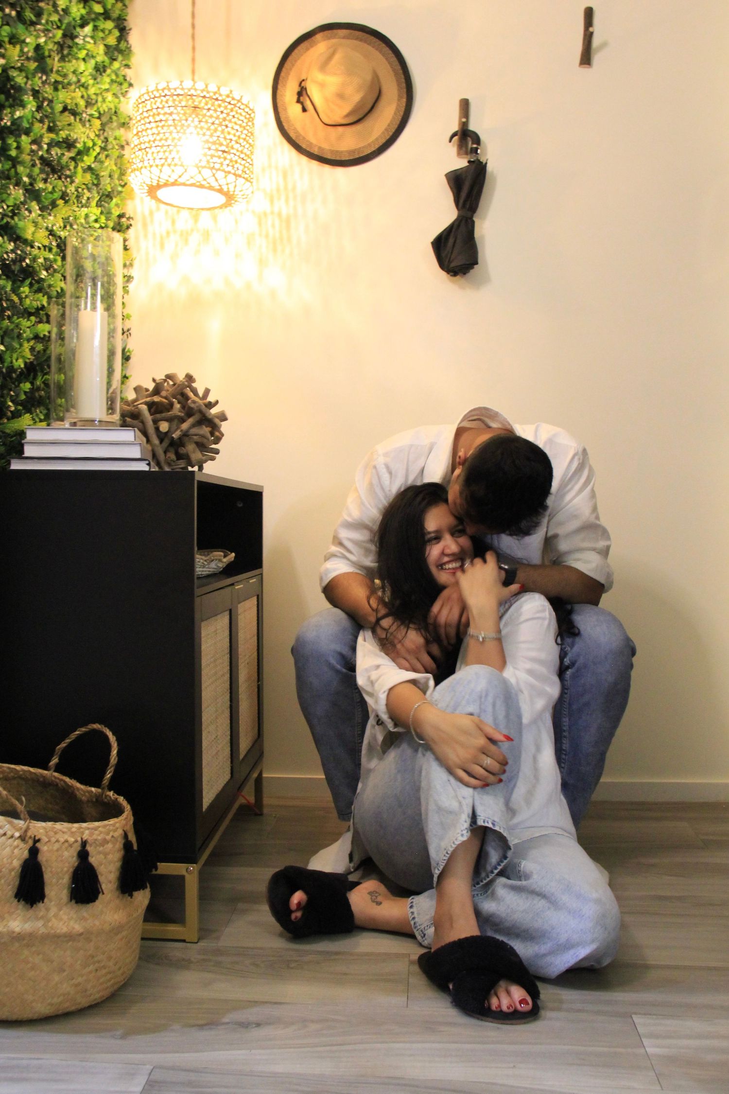 An intimate moment captured in a cozy corner with warm lighting and home decor.