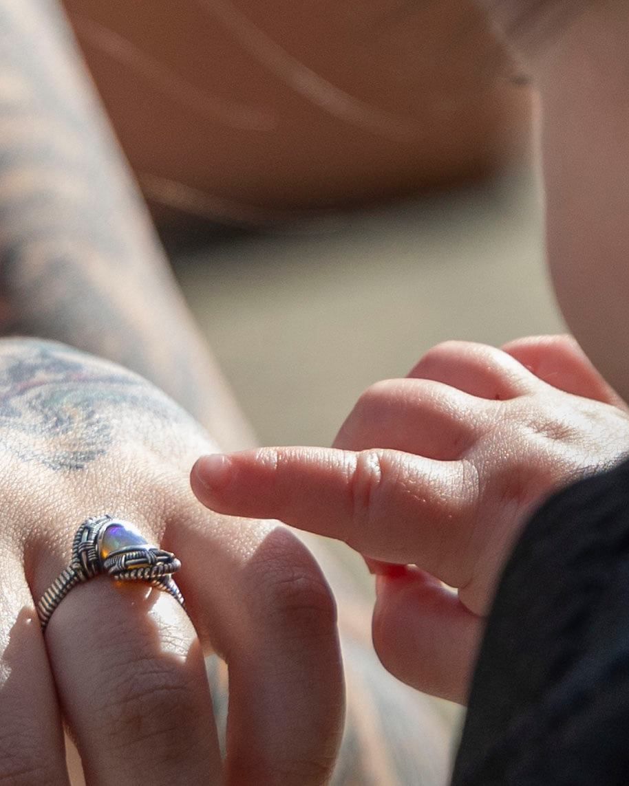 Close up of hands showing detail of ornate ring.