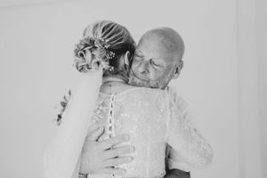 Emotional black and white moment captured during wedding preparations.