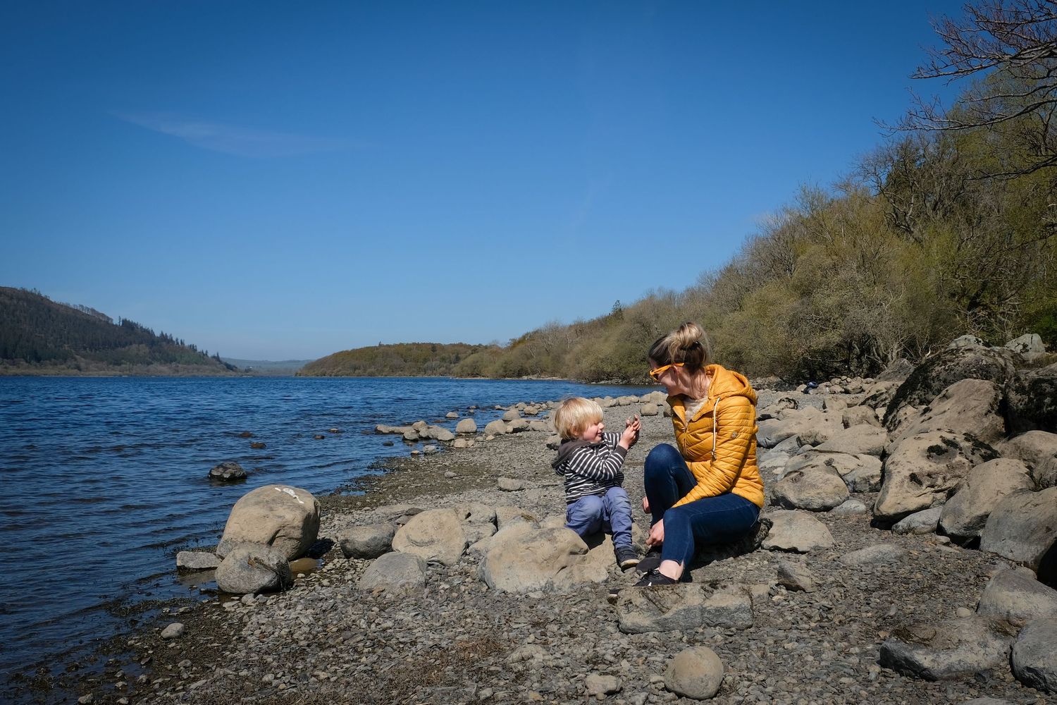 Kathryn and her son playing on the shore of Bassenthwaite Lake in the sunshine