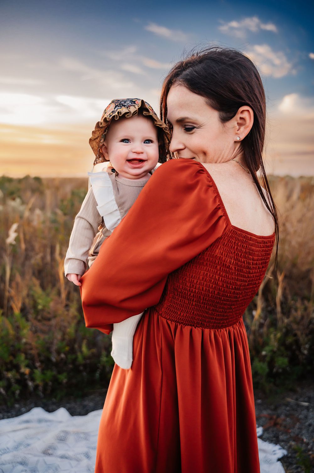 mother holding baby over shoulder with baby laughing in fielding Staten Island, NY