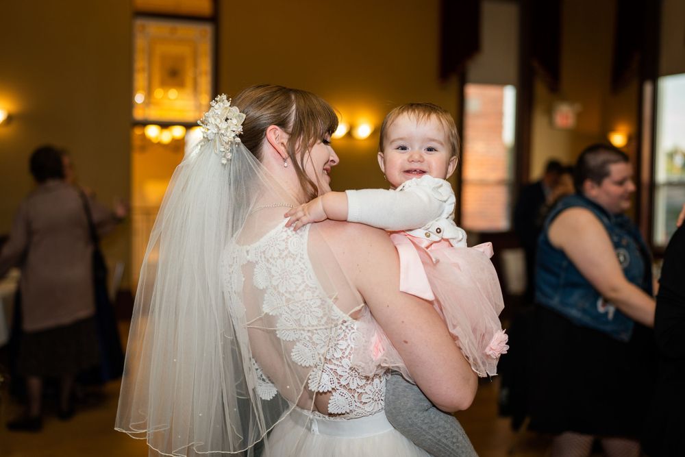 candid bride and baby dancing at acton town hall wedding reception