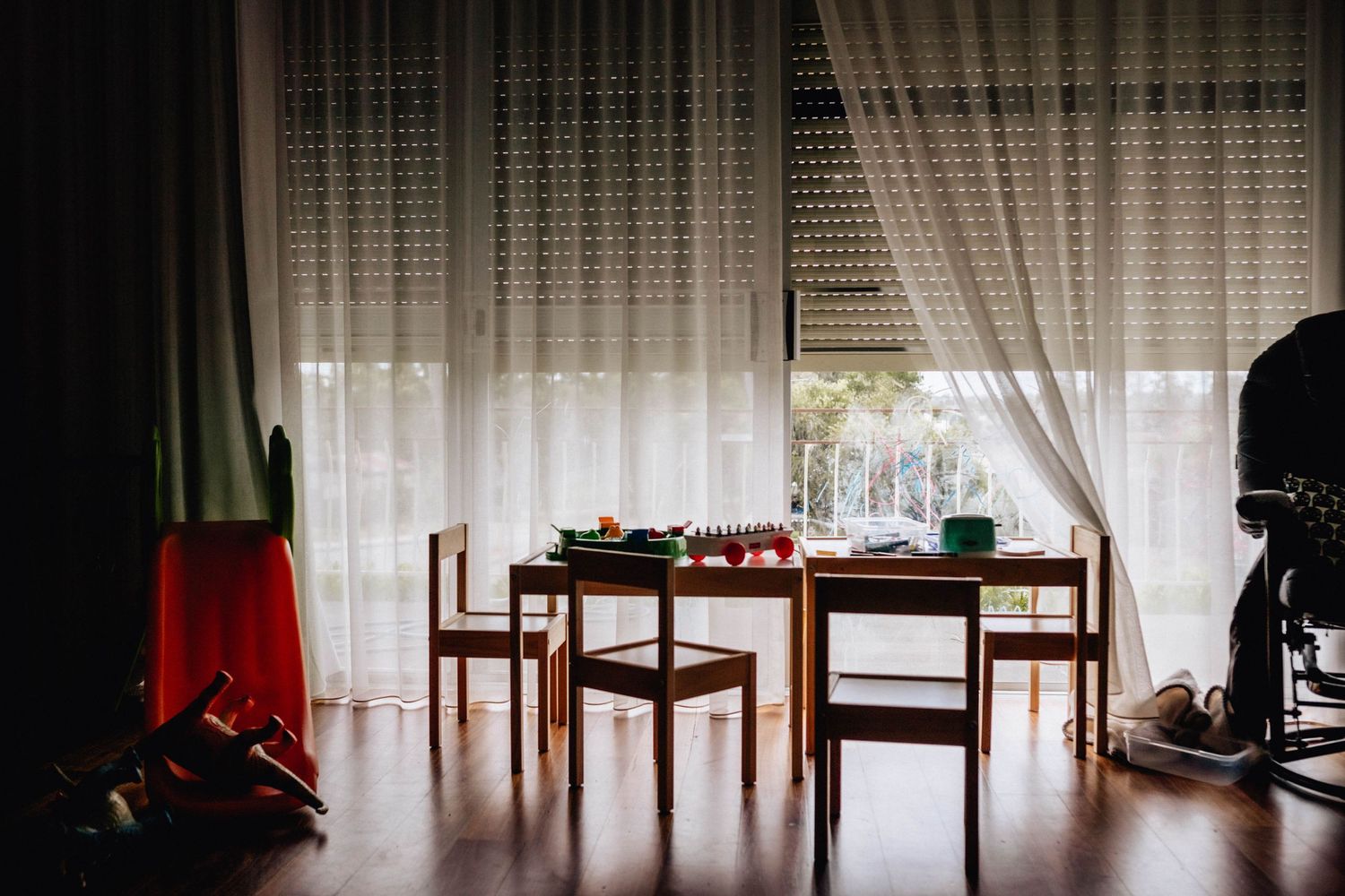 A kids play table in front of a bright window in a family home photo session