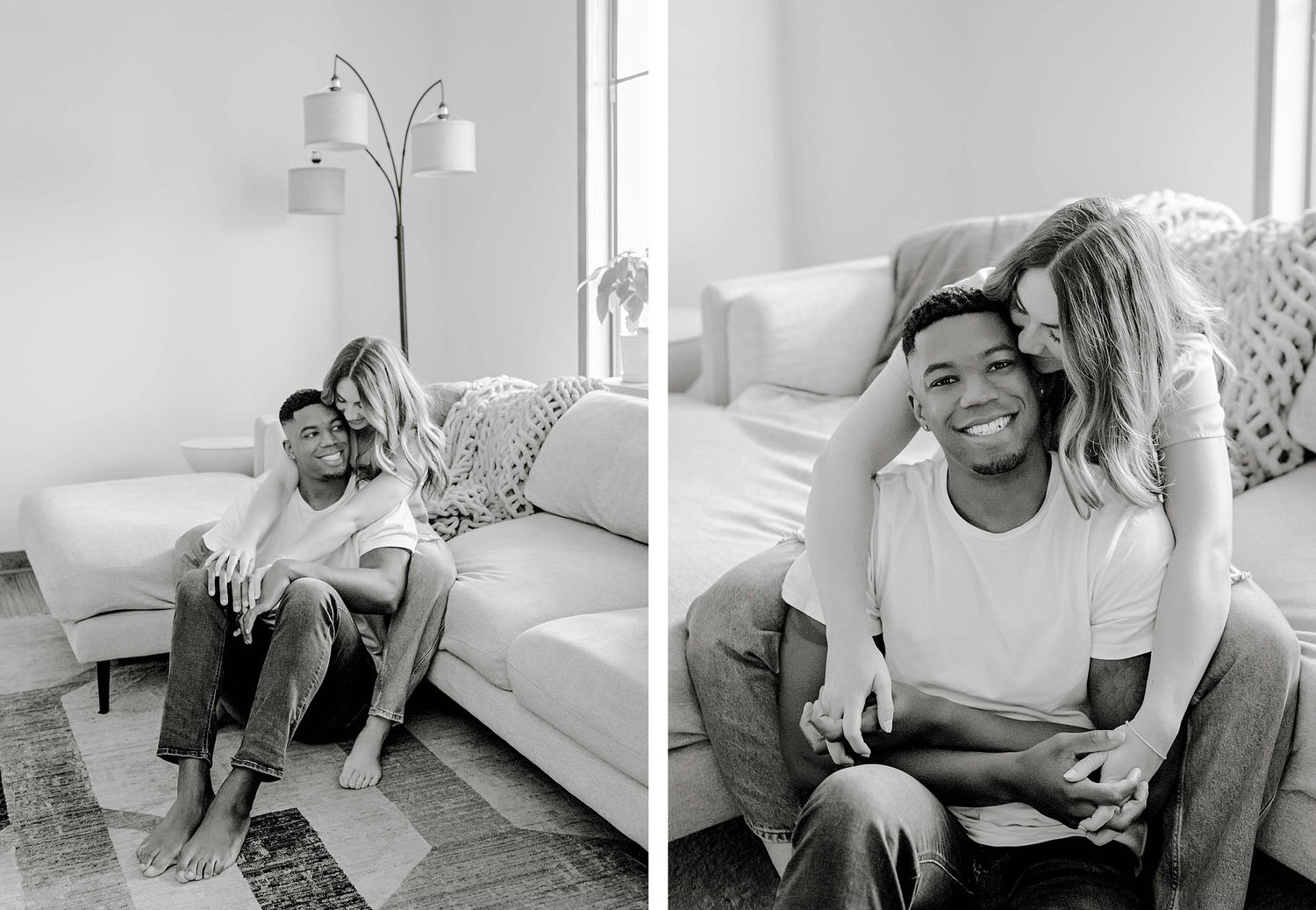 Loving couple relaxes together in bright modern living room with white couch and lamp.