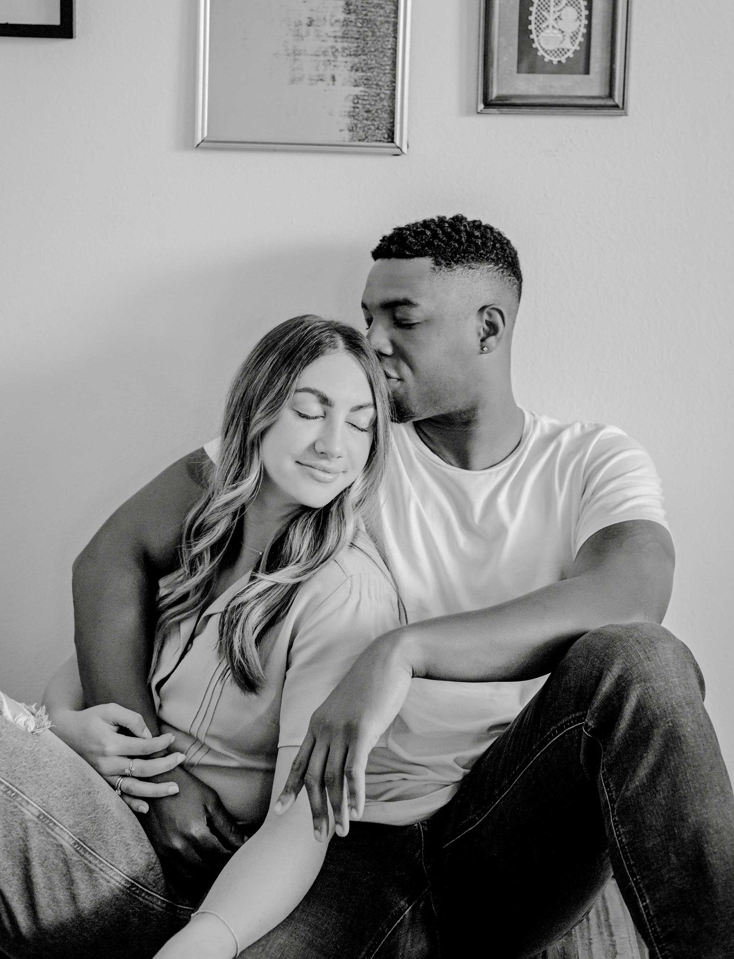 Black and white portrait capturing intimate moment in home setting.