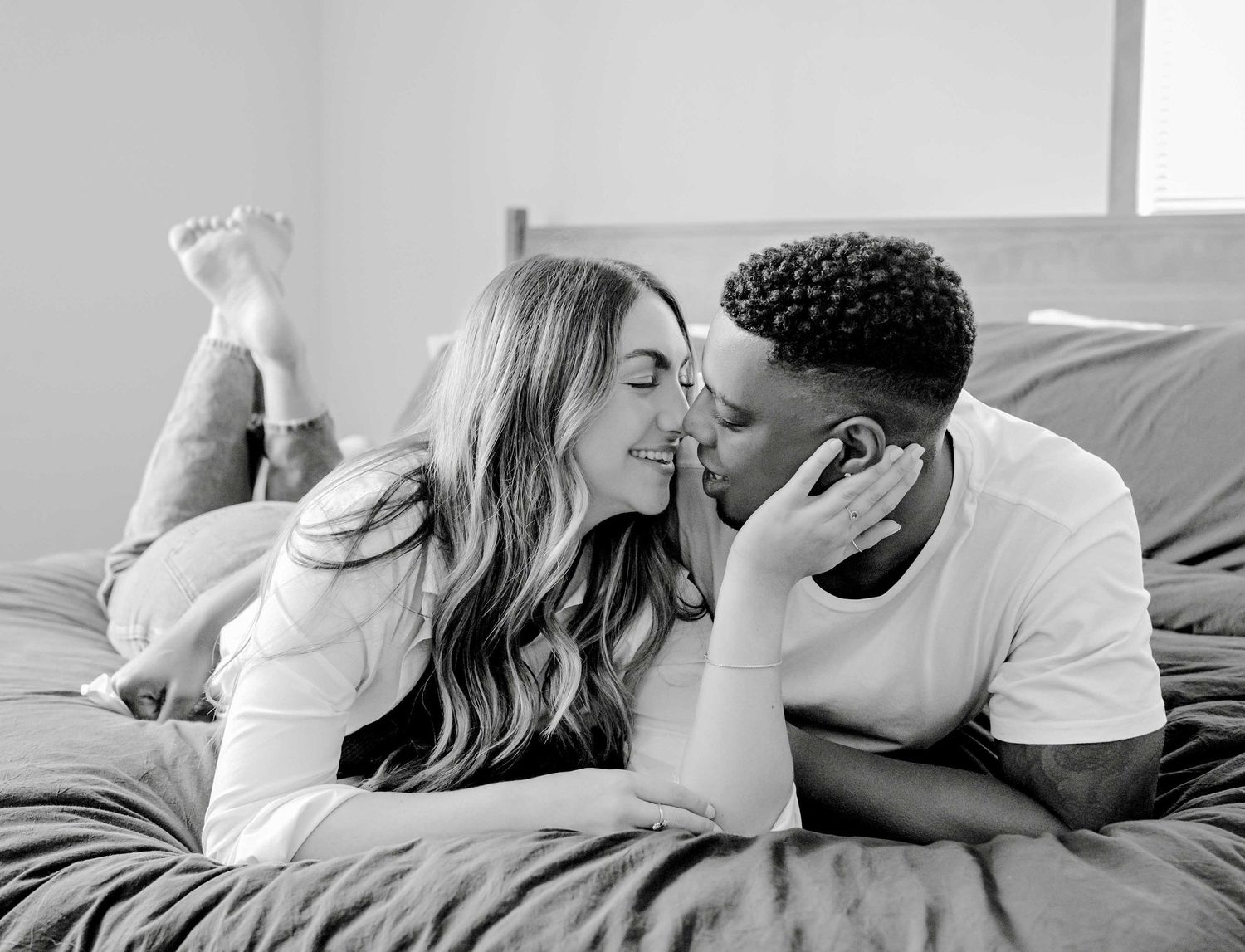 Intimate black and white bedroom photoshoot on gray bedding.
