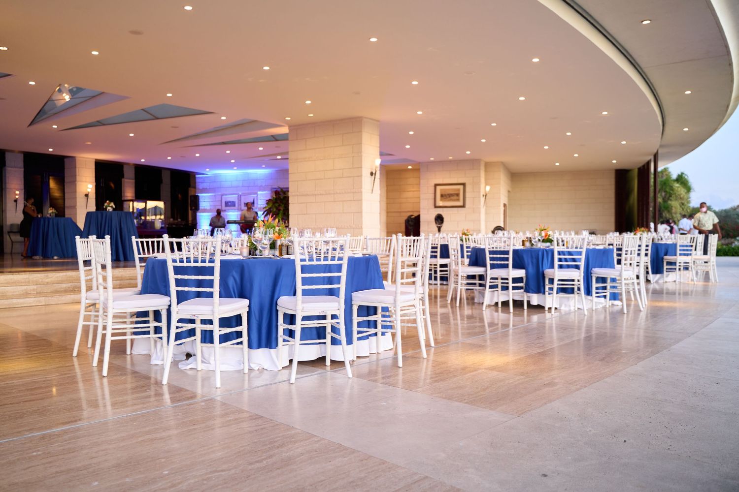Golf Club dinner setup with blue and white decor featuring elegant table settings.