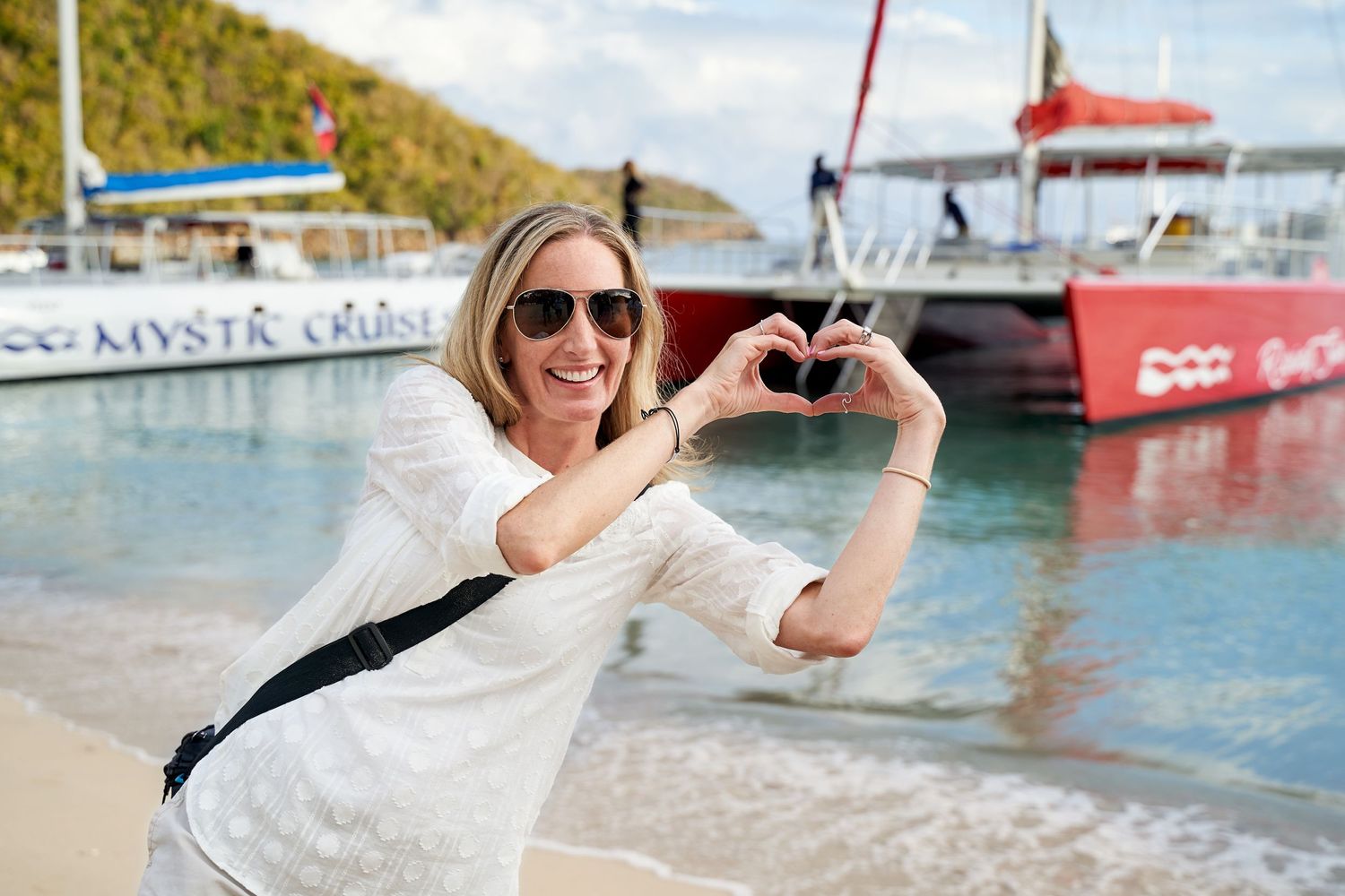 Tourist making heart shape gesture at before an Antiguan Catamaran cruise.
