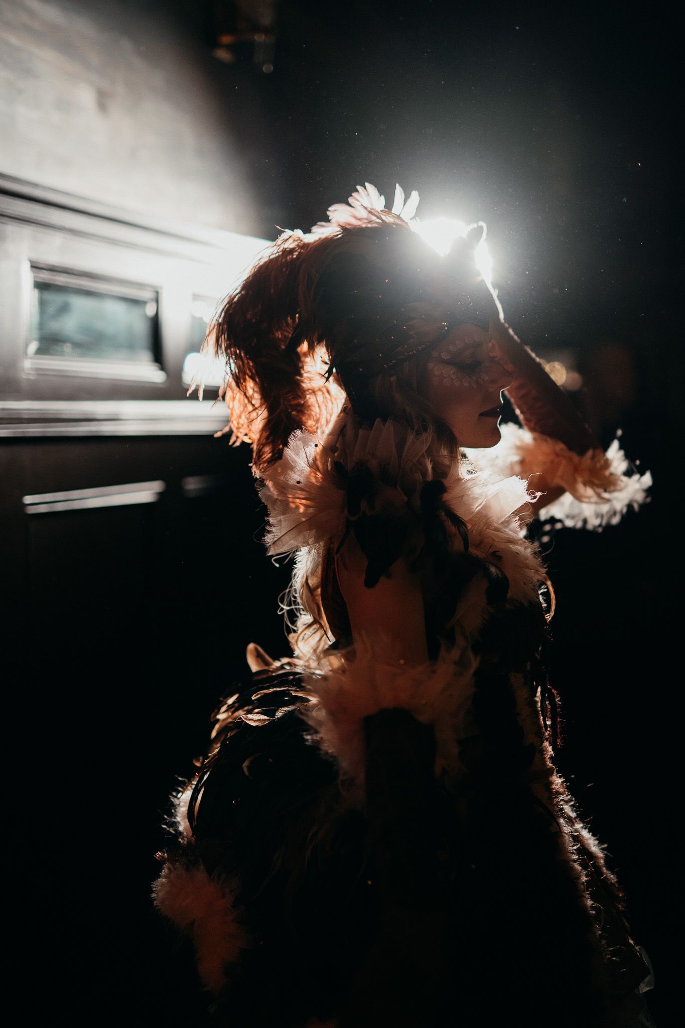 Dramatic backlit silhouette with light creating ethereal effect through flowing hair.