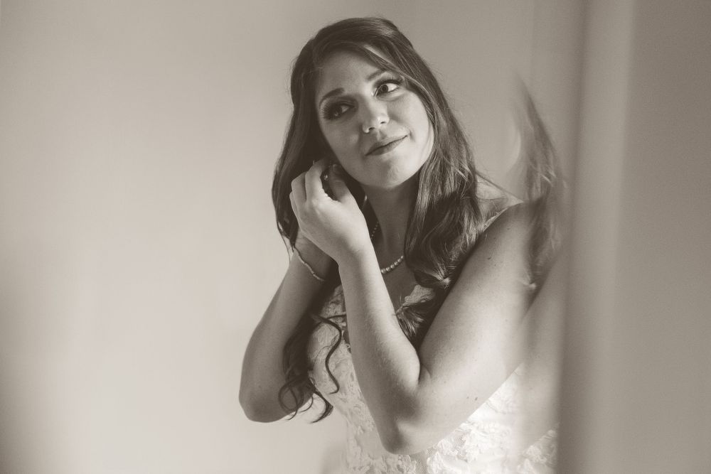 Candid photo of bride getting ready on her wedding day Macomb County Michigan