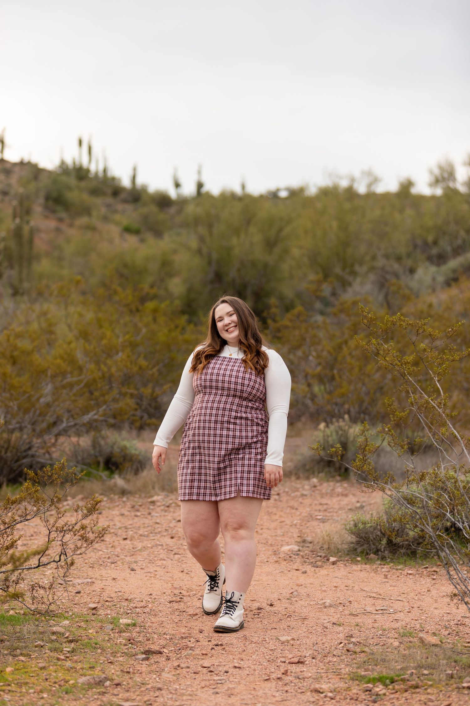 College senior smiling at the camera while walking.