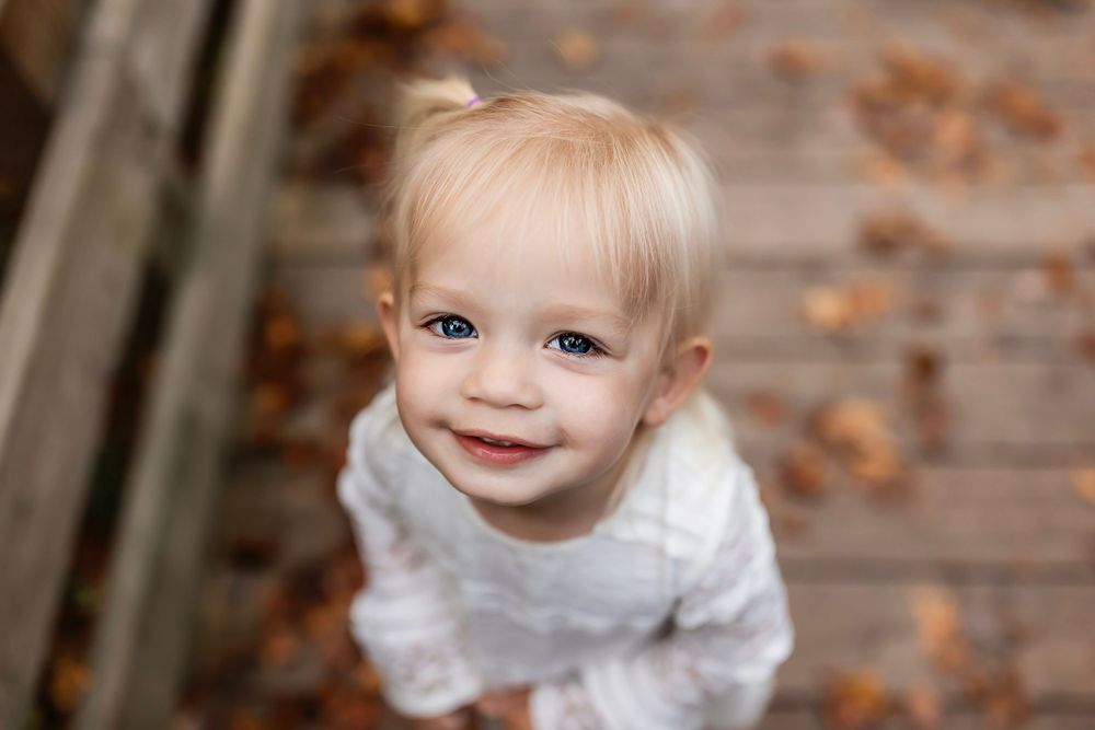 Close-up portrait with gentle natural light and neutral tones.