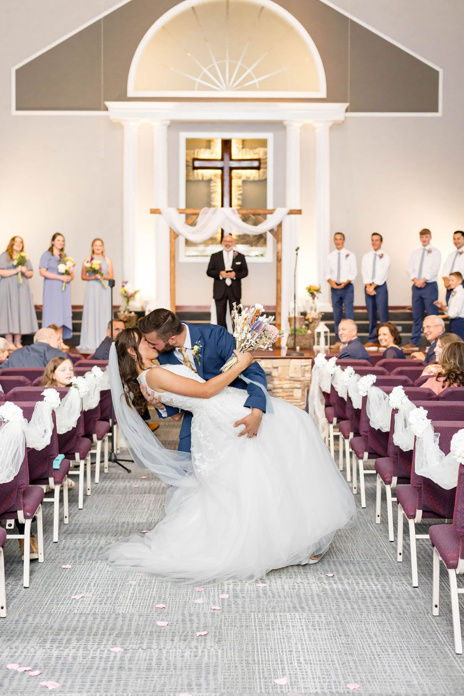 groom dips bride down the aisle
