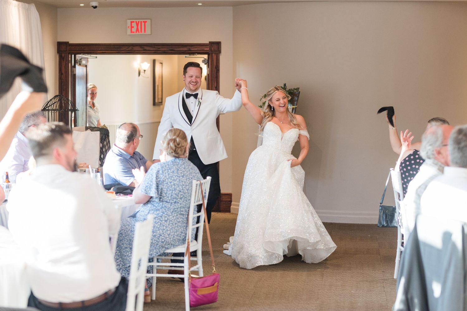 Wedding reception venue with white decor and modern seating arrangements in a bright interior space.