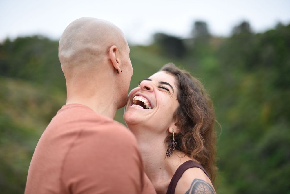 A couple shares a joyful moment together outdoors.
