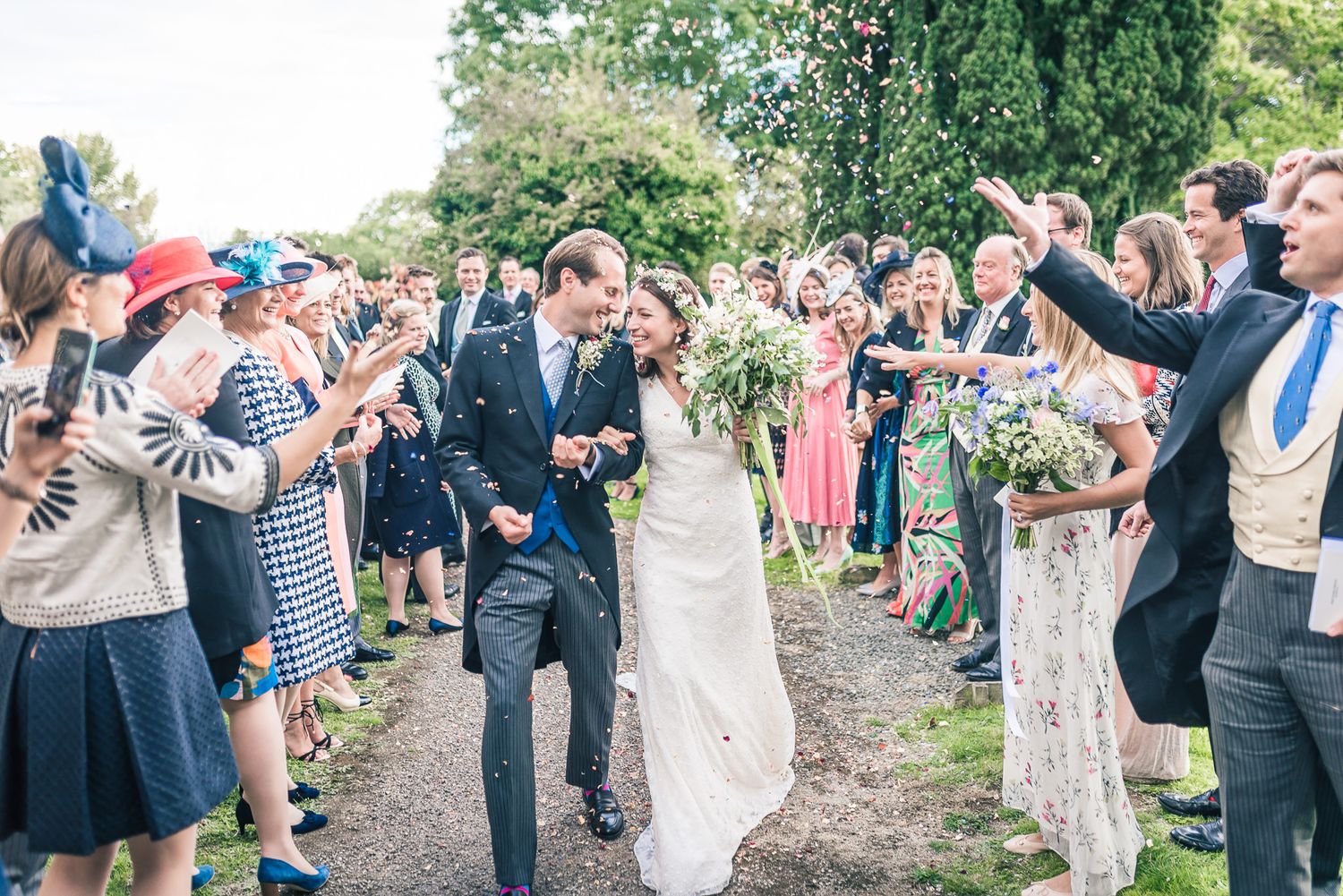 Wedding couple looking at each other whilst in a confetti tunnel