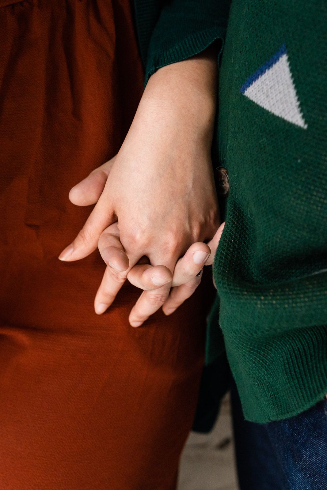 Close up photo of holding hands.