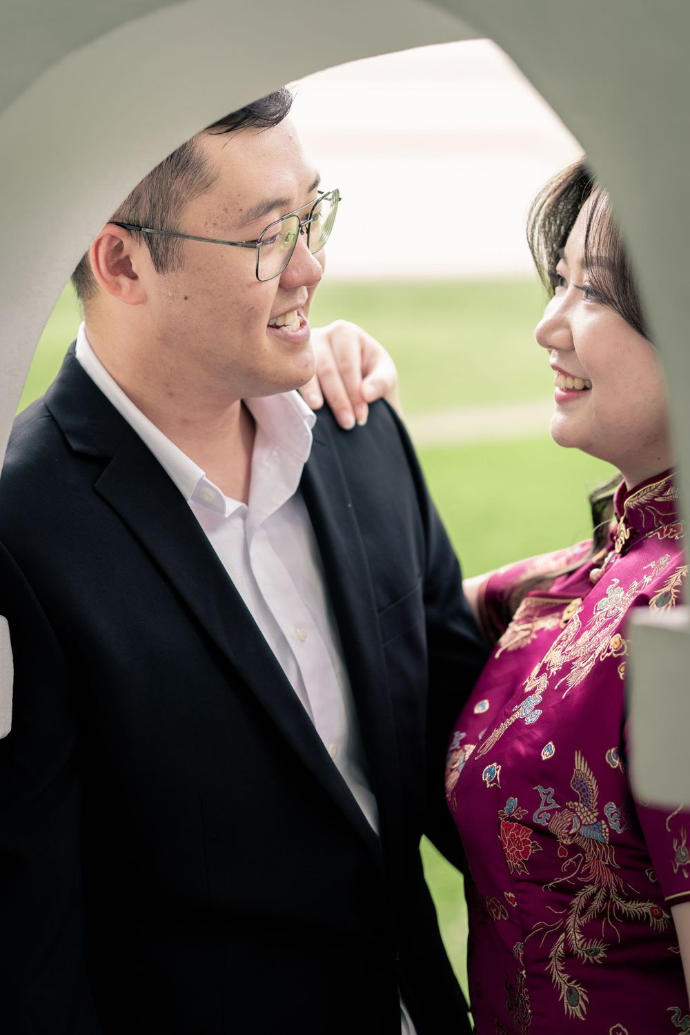 A romantic couple shares a tender moment while dressed in formal attire.