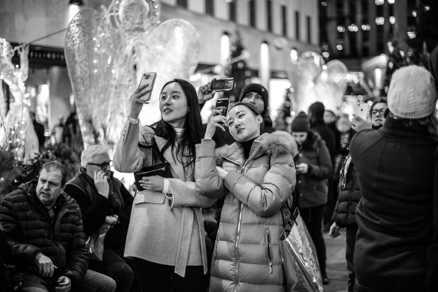 Asian tourists taking photos with phone in NYC