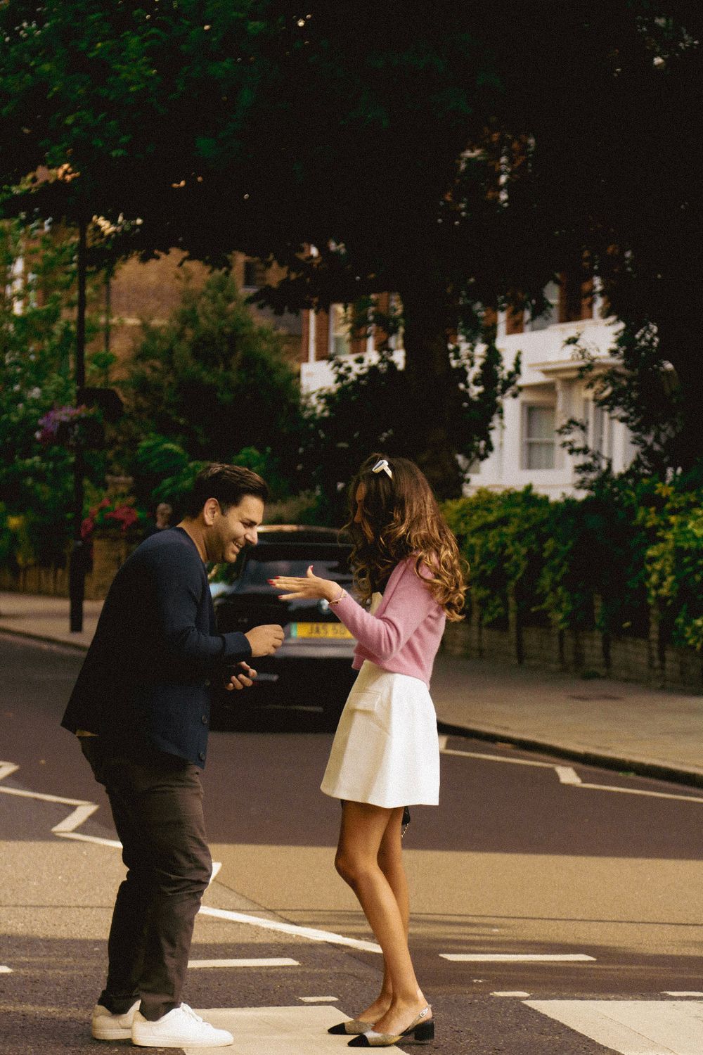 A joyful reaction captured during a marriage proposal on a city street.