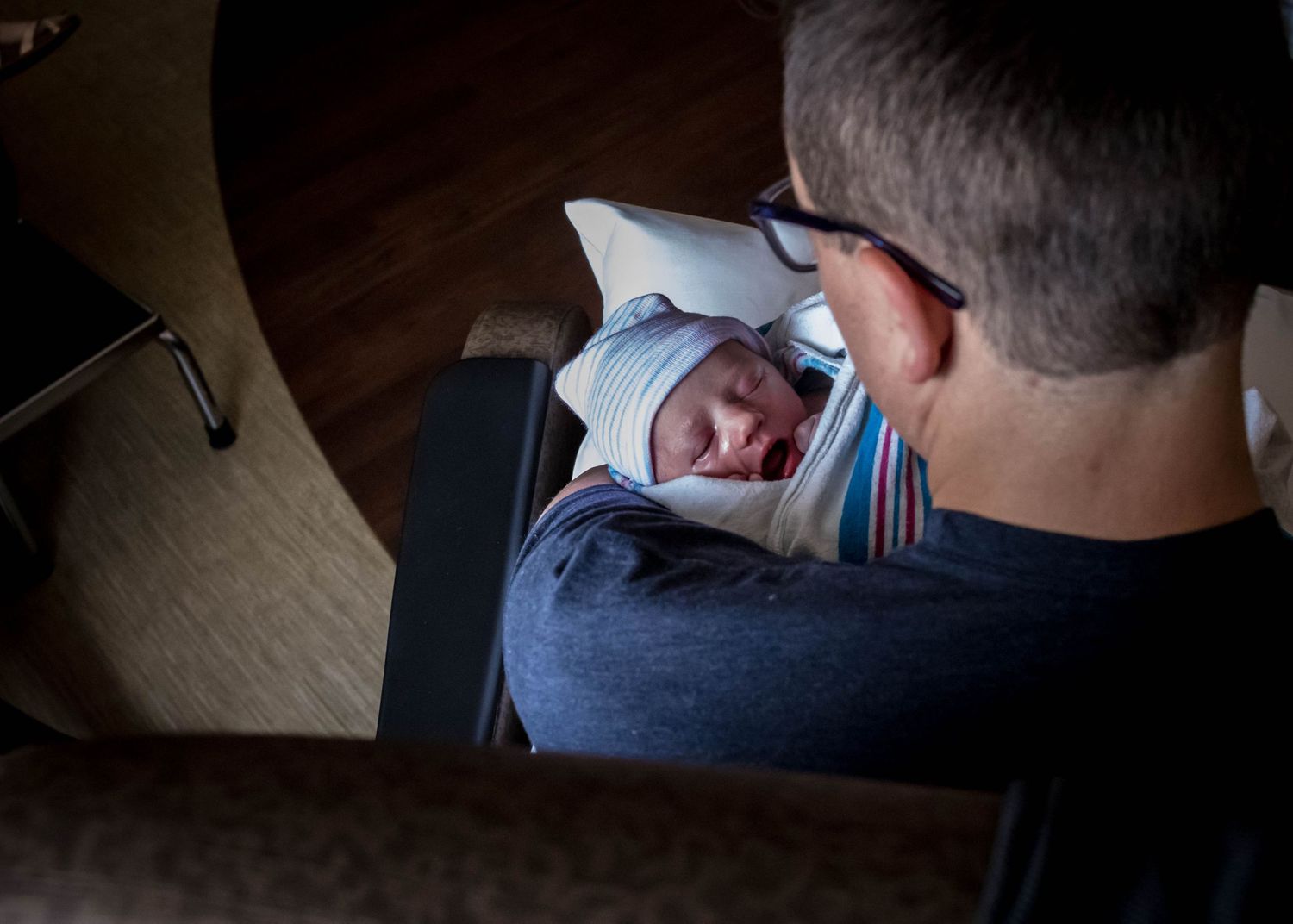 Daddy holding his baby girl just after birth for the first time in Sioux City, IA.