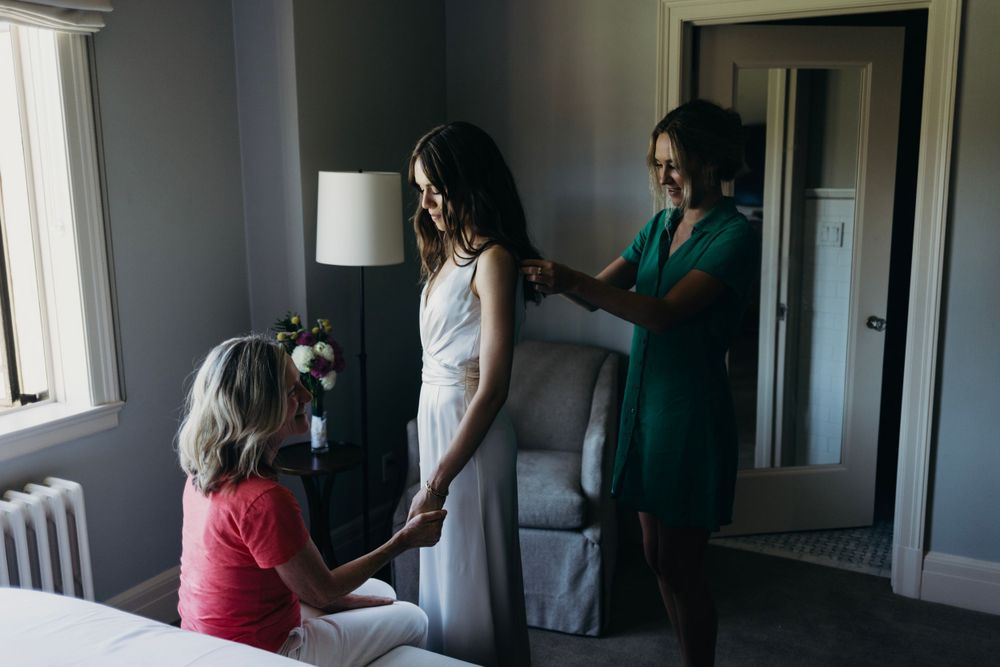 Elegant getting ready scene in a sunlit room with soft window light.