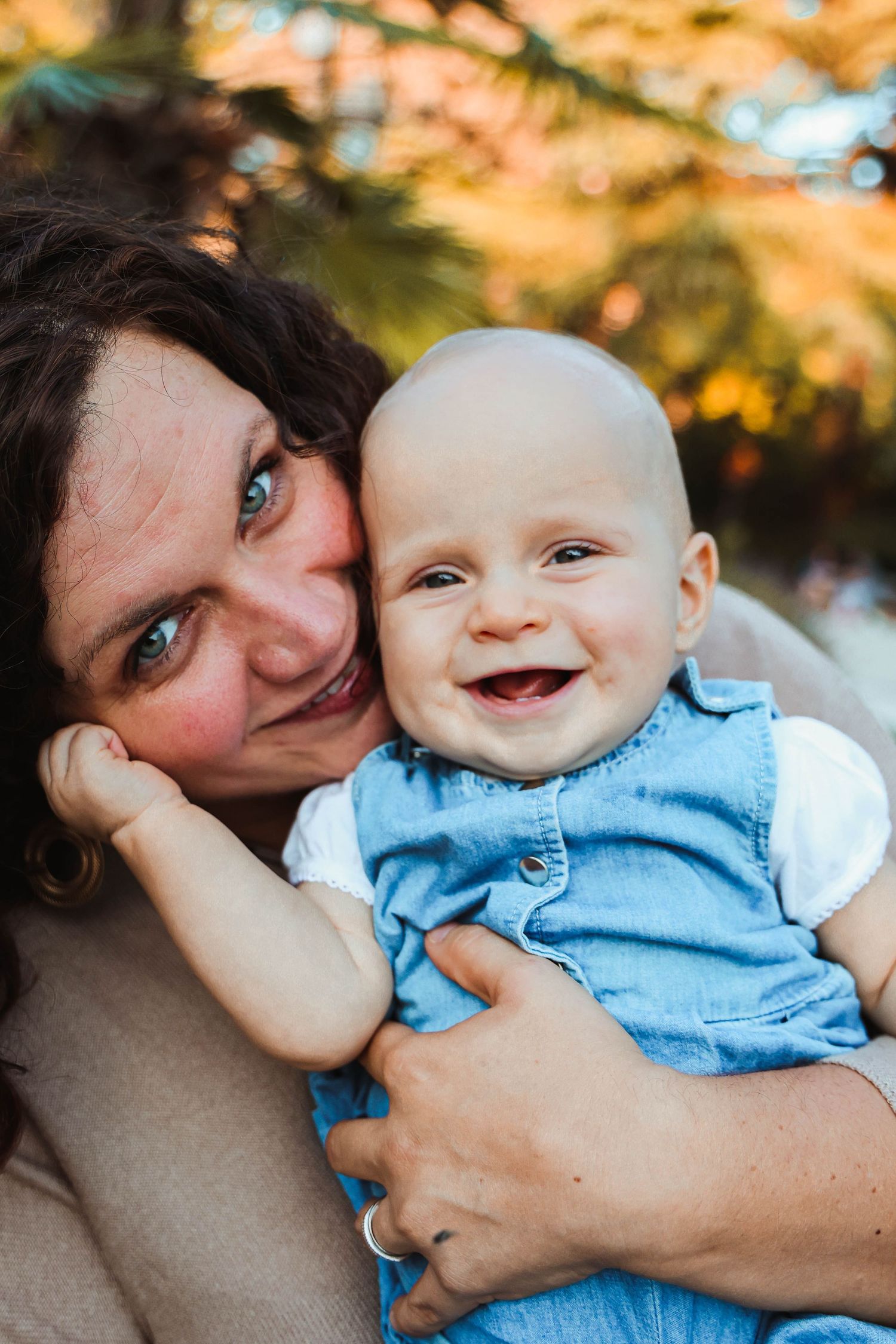 A sweet portrait of mother and baby sharing a laugh together.