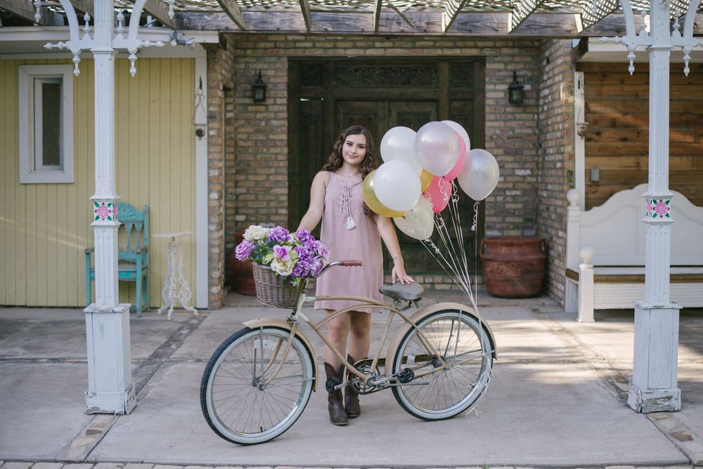 girl posing with a bike and balloons. Memory lane photo spot. Mission, Texas. Wedding photography